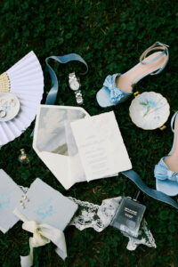 wedding detail photo featuring the brides shoes, jewelry, and wedding invitations