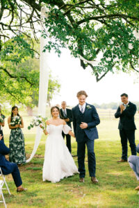 bride and groom walking back up the aisle at the top of the ceremony