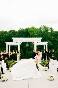 Bride and groom kissing in the aisle