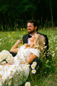 sweet wedding portrait of the couple laying in a field