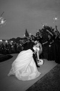 a dip kiss as the couple is leaving