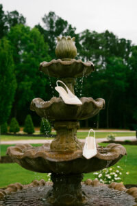 Detail photo with the brides shoes in a water fountain