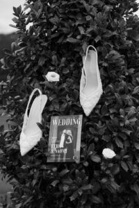 Detail photo of the brides shoes and the invitations